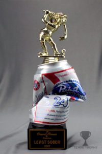 Custom trophy for "Least Sober" with golfer figurine on top, crushed PBR can, and black marble base.