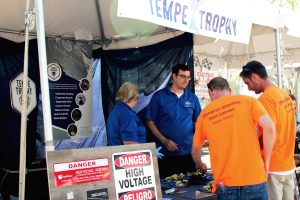 Electricians speaking to Jason and Connie Hood at the Tempe Trophy booth while picking up food.
