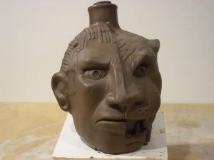 A clay sculpture of the original Apacalypto Tequila half Mayan, half jaguar bottle design by Odd Rodney.