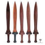 Five copper sword prototypes standing side by side with the final sword in the middle.