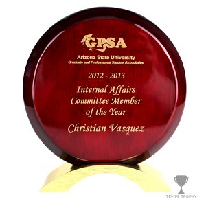 Maroon circular plaque engraved with gold by Tempe Trophy.