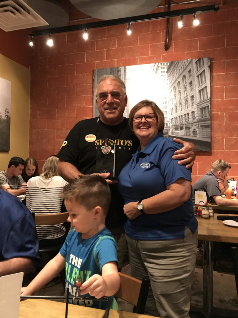Sue posing with the owner of Spinelli's as he receives their Best of Tempe Trophy award.