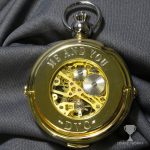 Engraved skeleton gold pocket watch