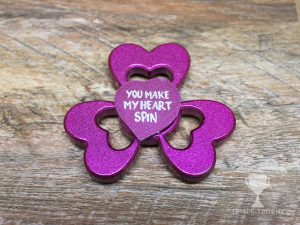 Purple fidget spinner with hearts as arms and engraved