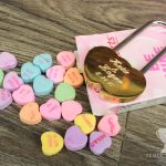 Engraved classic gold double heart love lock on a box of Sweethearts
